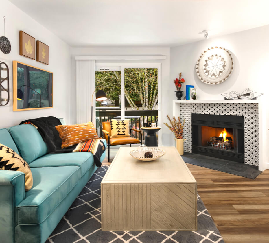 Living room at Scout with a tiled fireplace, teal couch, and a coffee table